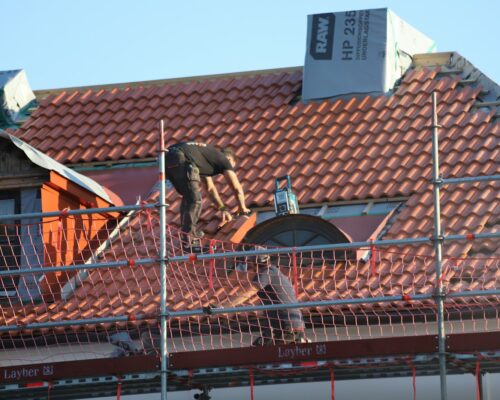 A man on a roof working on a roof